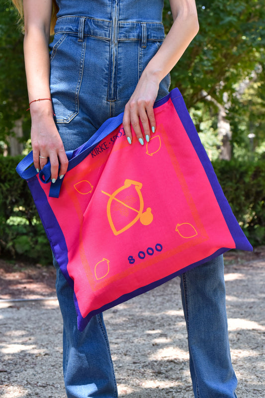 Model holding Saperavi tote bag in outdoor setting